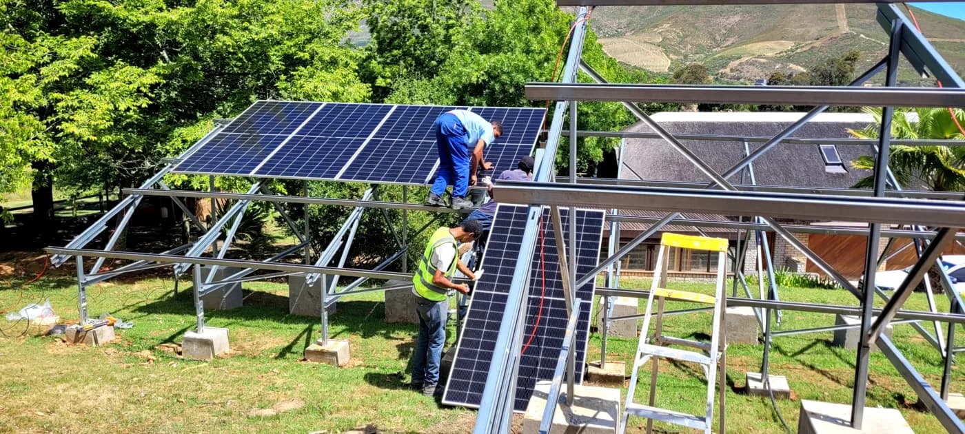 Solaris installation team assembling a ground-mount structure